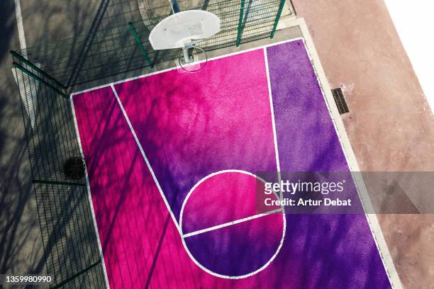 artistic colorful basketball court seen from above by drone. - diversity color surge stock-fotos und bilder