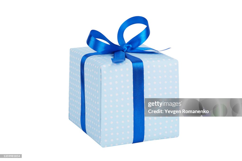 Gift box wrapped in Blue paper with blue ribbon bow, isolated on white