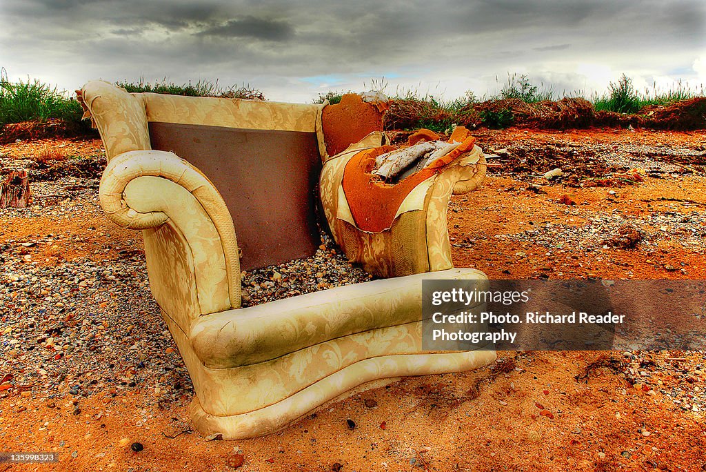 Abandoned armchair on beach