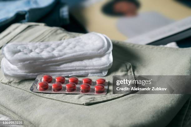 sanitary napkins and pads for the menstrual cycle. women's accessories, pills, medicines on jeans. packing for the trip, take your personal belongings with you. the concept of critical days, menstruation. health care, gynecology. healthcare and medicine. - incontinence stock pictures, royalty-free photos & images