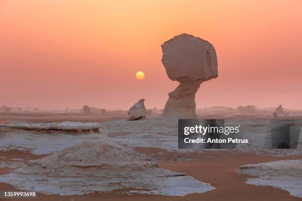 limestone rock formations in the white desert at sunset. egypt, western sahara desert - tierra salvaje fotografías e imágenes de stock