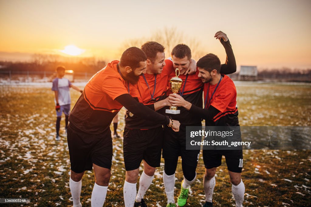 Football team celebrating a trophy