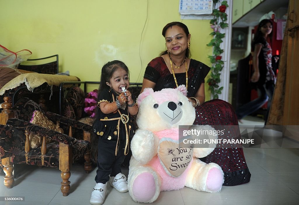 Jyoti Amge poses with her elder sister Vaishali at their residence in