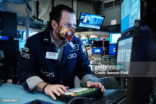 Trader works on the floor of the New York Stock Exchange at the start of trading on Monday following Friday’s steep decline in global stocks over...