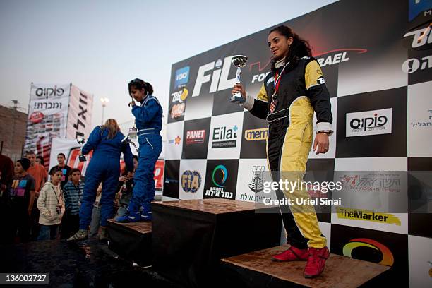 Palestinian Noor Daoud holds a trophy after she won 3rd place in first day of Formula Israel's women race, Israel's first legal car race on December...