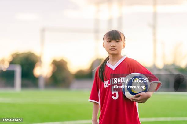 portrait of elementary age female football or soccer player - young girl soccer stock pictures, royalty-free photos & images