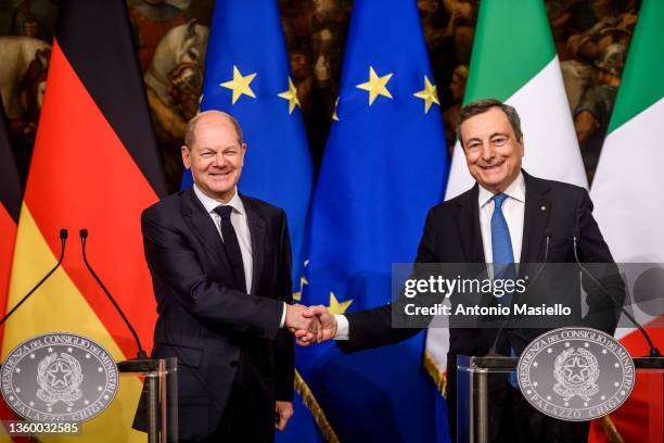 Italian Prime Minister Mario Draghi and German Chancellor Olaf Scholz shake hands during the joint press conference following their meeting at...
