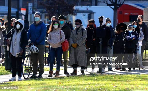 Hundreds of people wait in line to be tested for COVID-19 at a free clinic in Farragut Square on December 20, 2021 in Washington, DC. The District of...
