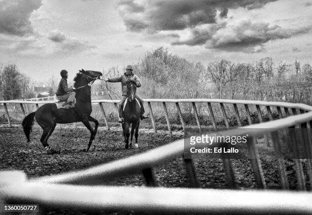 View of an unidentified jockey and trainer astride horse--one of which is Devil's Bag at Keeneland Race Track, Lexington, Kentucky, April 13, 1984.