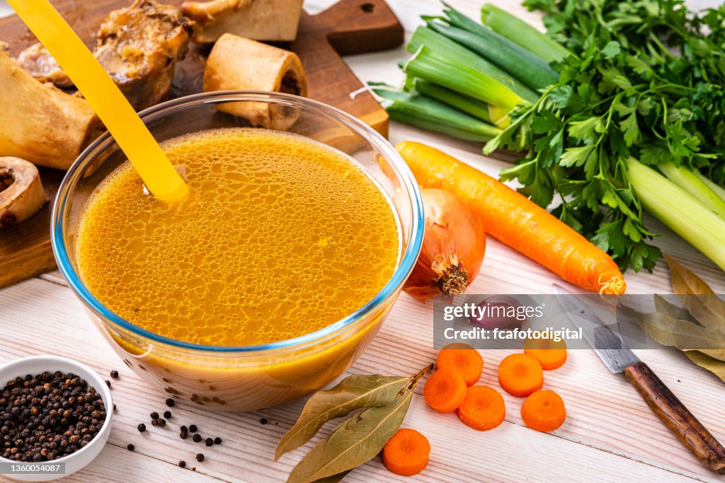 Bone broth in a bowl on white table