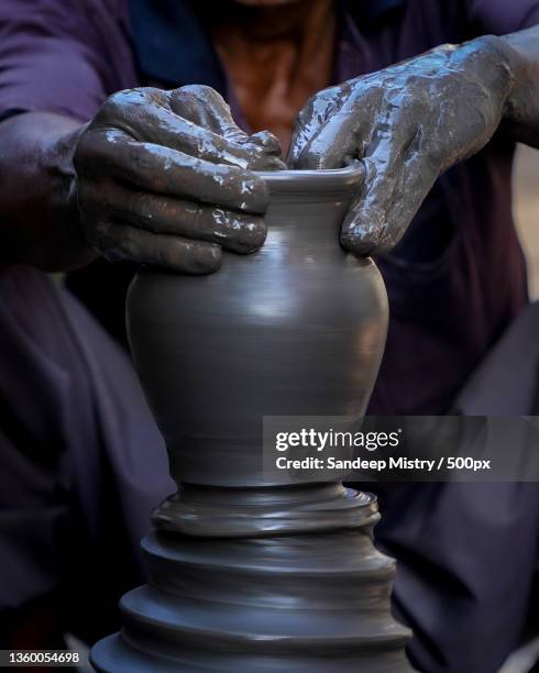 midsection of man making pot,india - loam fotografías e imágenes de stock