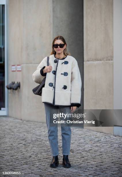 Aline Kaplan wearing shearling jacket Source Unknown, jumper Arket, Jeans: Zara, bag & boots Copenhagen Studios on December 17, 2021 in Berlin,...