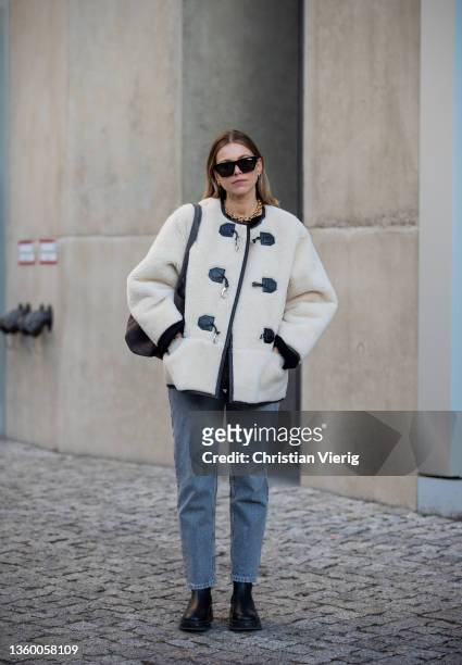 Aline Kaplan wearing shearling jacket Source Unknown, jumper Arket, Jeans: Zara, bag & boots Copenhagen Studios on December 17, 2021 in Berlin,...