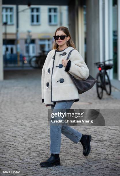 Aline Kaplan wearing shearling jacket Source Unknown, jumper Arket, Jeans: Zara, bag & boots Copenhagen Studios on December 17, 2021 in Berlin,...