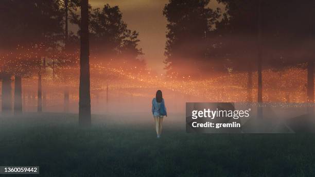 surreal abstract floating lights with woman walking in fantasy forest - force field stock pictures, royalty-free photos & images
