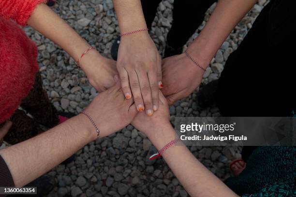 a group of young people put their hands together in bersive camp near zakho, northern iraq. - yazidis ストックフォトと画像