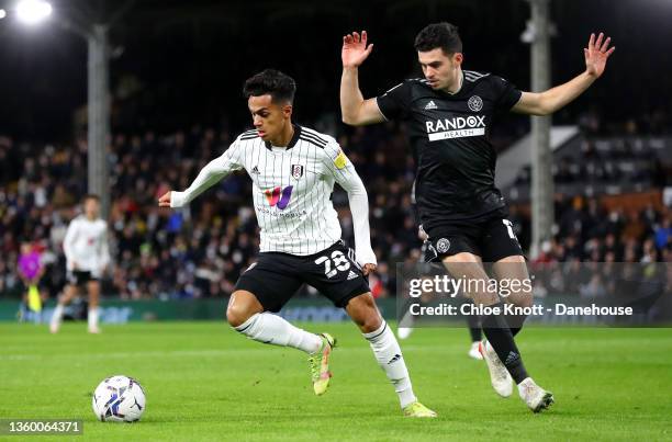 Fabio Carvalho of Fulham FC and John Egan of Sheffield United in action during the Sky Bet Championship match between Fulham and Sheffield United at...