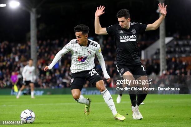 Fabio Carvalho of Fulham FC and John Egan of Sheffield United in action during the Sky Bet Championship match between Fulham and Sheffield United at...