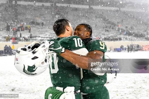 Payton Thorne and Kenneth Walker III of the Michigan State Spartans celebrate their win against the Penn State Nittany Lions at Spartan Stadium on...