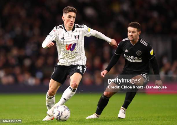 Harry Wilson of Fulham FC controls the ball under pressure of Oliver Norwood of Sheffield United during the Sky Bet Championship match between Fulham...