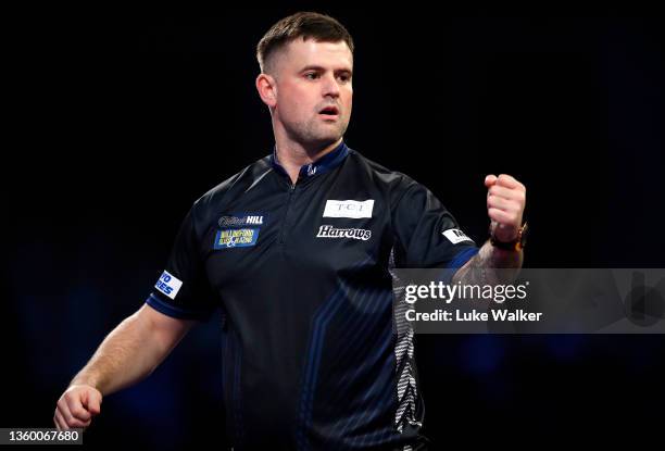 Luke Woodhouse of England in action during his Round One match against James Wilson of England during The William Hill World Darts Championship at...