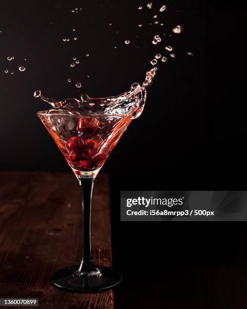 close-up of wineglass against black background - splashing cocktail stock pictures, royalty-free photos & images