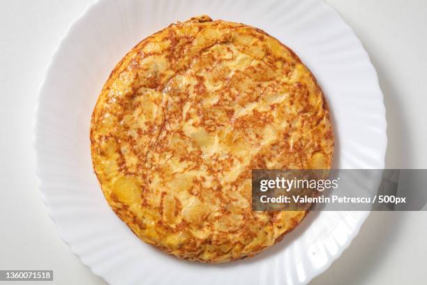 spanish omelette on white plate,high angle view of pizza in plate on white background - fried potato stock pictures, royalty-free photos & images