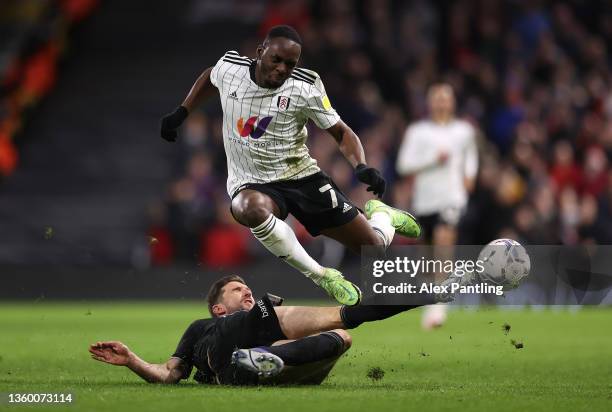 Neeskens Kebano of Fulham is tacked by Chris Basham of Sheffield United during the Sky Bet Championship match between Fulham and Sheffield United at...