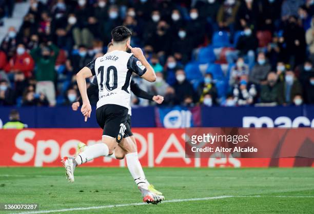 Carlos Soler of Valencia CF celebrates after scoring his team's second goal during the LaLiga Santander match between Levante UD and Valencia CF at...