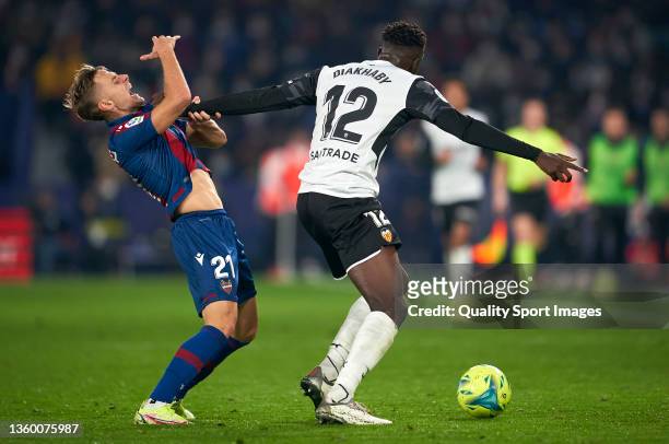 Dani Gomez of Levante UD competes for the ball with Mouctar Diakhaby of Valencia CF during the La Liga Santander match between Levante UD and...