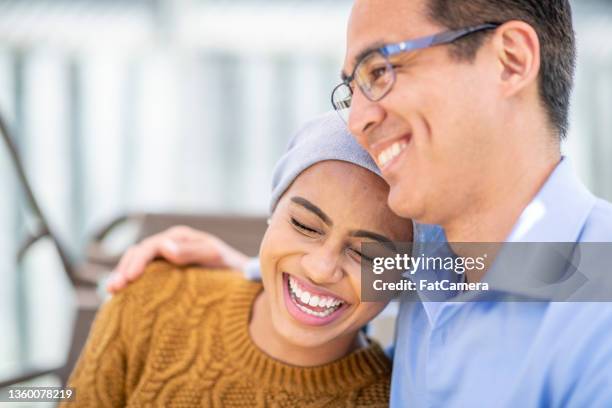 cancer patient sitting outside with her father - cancer patient with family stock pictures, royalty-free photos & images