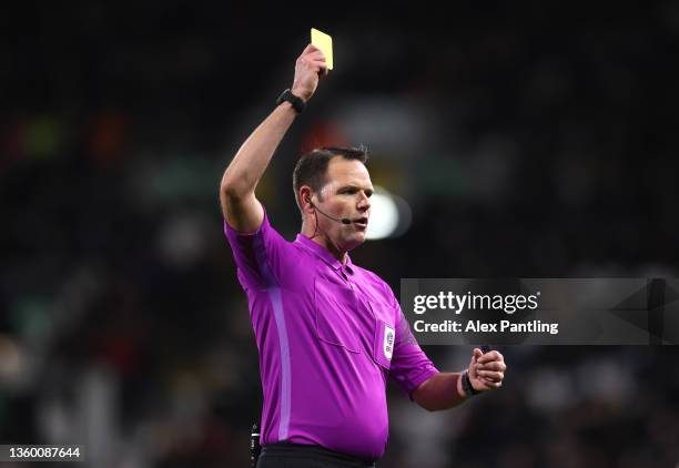 Referee James Linington shows a yellow card during the Sky Bet Championship match between Fulham and Sheffield United at Craven Cottage on December...