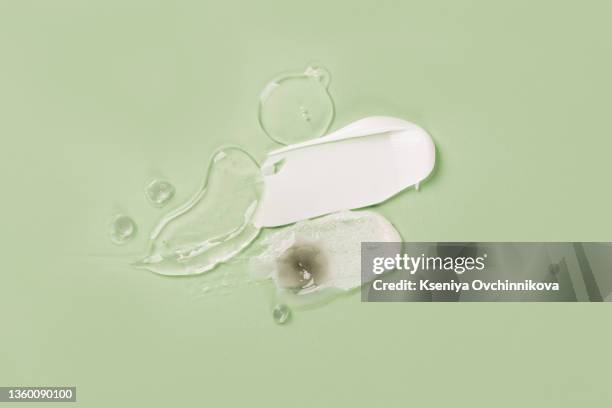 image of cream smear green background - cosmetics cream stock pictures, royalty-free photos & images