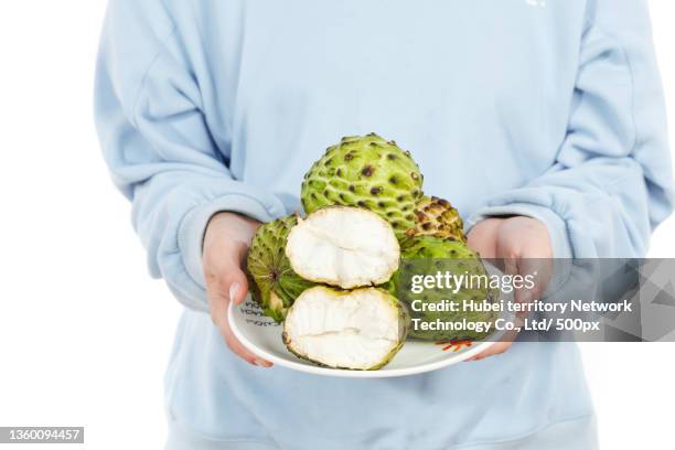 with milk and sakyamuni in his hand - cherimoya stock pictures, royalty-free photos & images