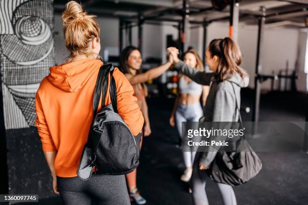 group of gymters greeting on the way in to workout - gym friends stock pictures, royalty-free photos & images