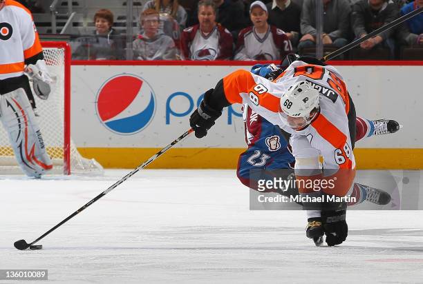 Jaromir Jagr of the Philadelphia Flyers and Milan Hejduk of the Colorado Avalanche collide at the Pepsi Center on December 19, 2011 in Denver,...