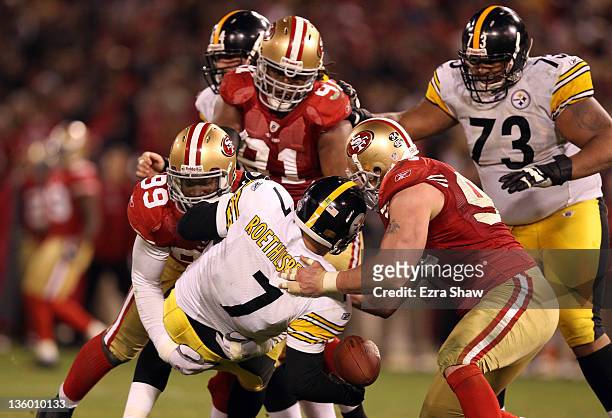 Ben Roethlisberger of the Pittsburgh Steelers fumbles the ball after being sacked by Aldon Smith and Justin Smith of the San Francisco 49ers at...