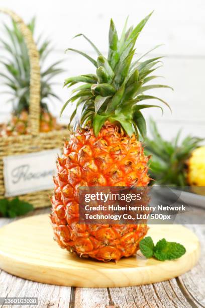 there are taiwan golden diamond pineapples on the board - ananas aufgeschnitten stock-fotos und bilder