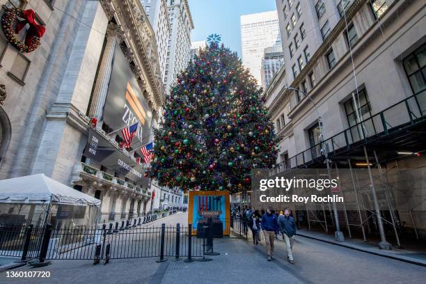 Christmas tree with a Kwanzaa kinara in front stands in front of The New York Stock Exchange on the corner of Broad St. And Wall St. On December 20,...