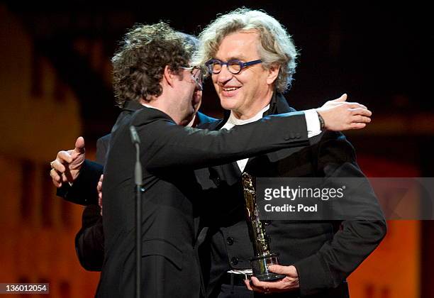 German director Wim Wenders is congratulated by producer Gian Piero Ringel after receiving the 'European Film Academy Documentary 2011 - Prix Arte'...