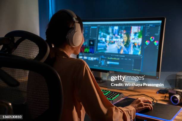 in the creative agency beautiful young woman videographer works on her personal computer - redacteur stockfoto's en -beelden