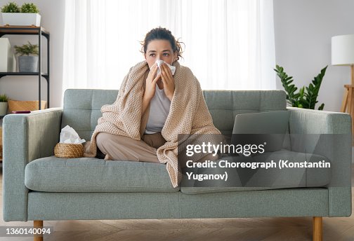 Girl is holding paper tissue and blowing nose Girl is holding paper tissue and blowing nose