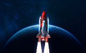 Space shuttle flight in deep space. Space rocket on orbit of Earth planet. Sci-fi space wallpaper. Elements of this image furnished by NASA