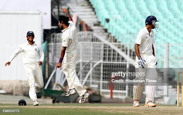 Ashok Dinda of Bengal celebrates after taking the wicket of Delhi batsman Ankur Julka in the 2nd innings during the Ranji Trophy match between Delhi...