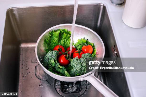 fresh ripe vegetables in sieve in kitchen sink. - sieve stock pictures, royalty-free photos & images
