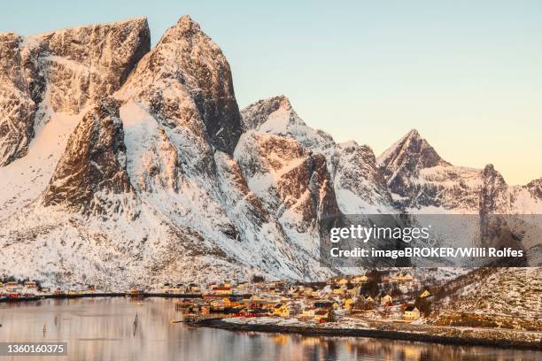 scandinavian landscape with boathouses at the fjord, sea, mountains, snow, hamnoey, nordland, lofoten, norway - moskenesoya stock pictures, royalty-free photos & images