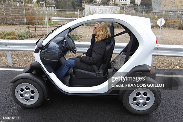 Woman sits in a new Renault electric car Twizy Z.E on a test track, on December 20, 2011 at the Ile Séguin test centre for electric vehicles in...