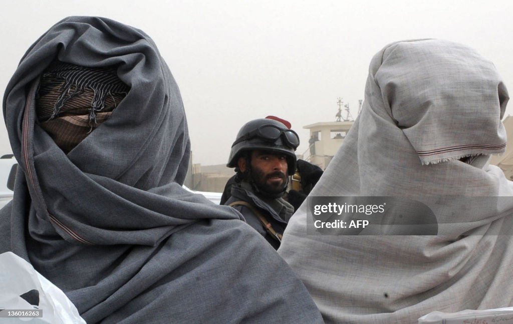 Taliban fighters stand with covered face