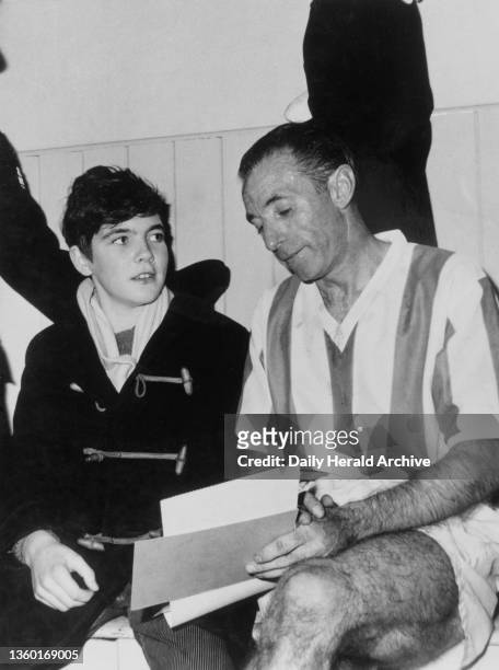 Stanley Matthews returns to Stoke shown here signing an autograph for John Elkes, a 14 year old patient of Hartshill Orthapaedic Hospital in the...