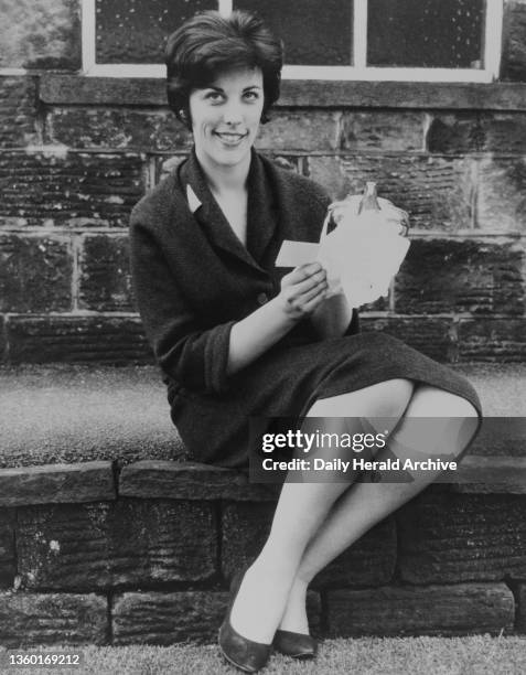 Patricia Ridgeway, due to marry Spike Milligan, photographed here with a silver teapot, one of their many wedding presents, 1962.